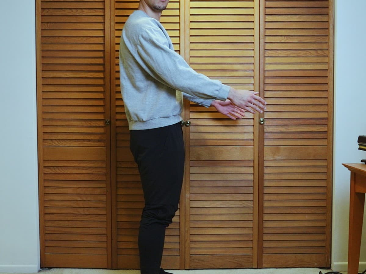 Man posing at 90 degree angle from the camera.