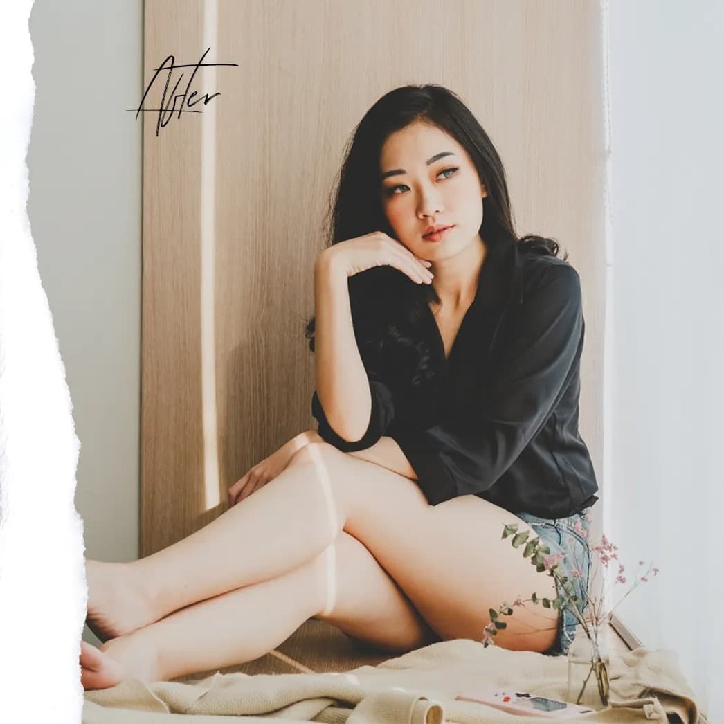 Woman sitting on floor looking left.