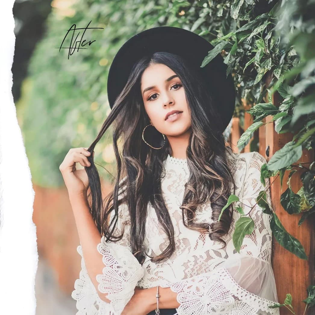 Woman with hat playing with her hair.