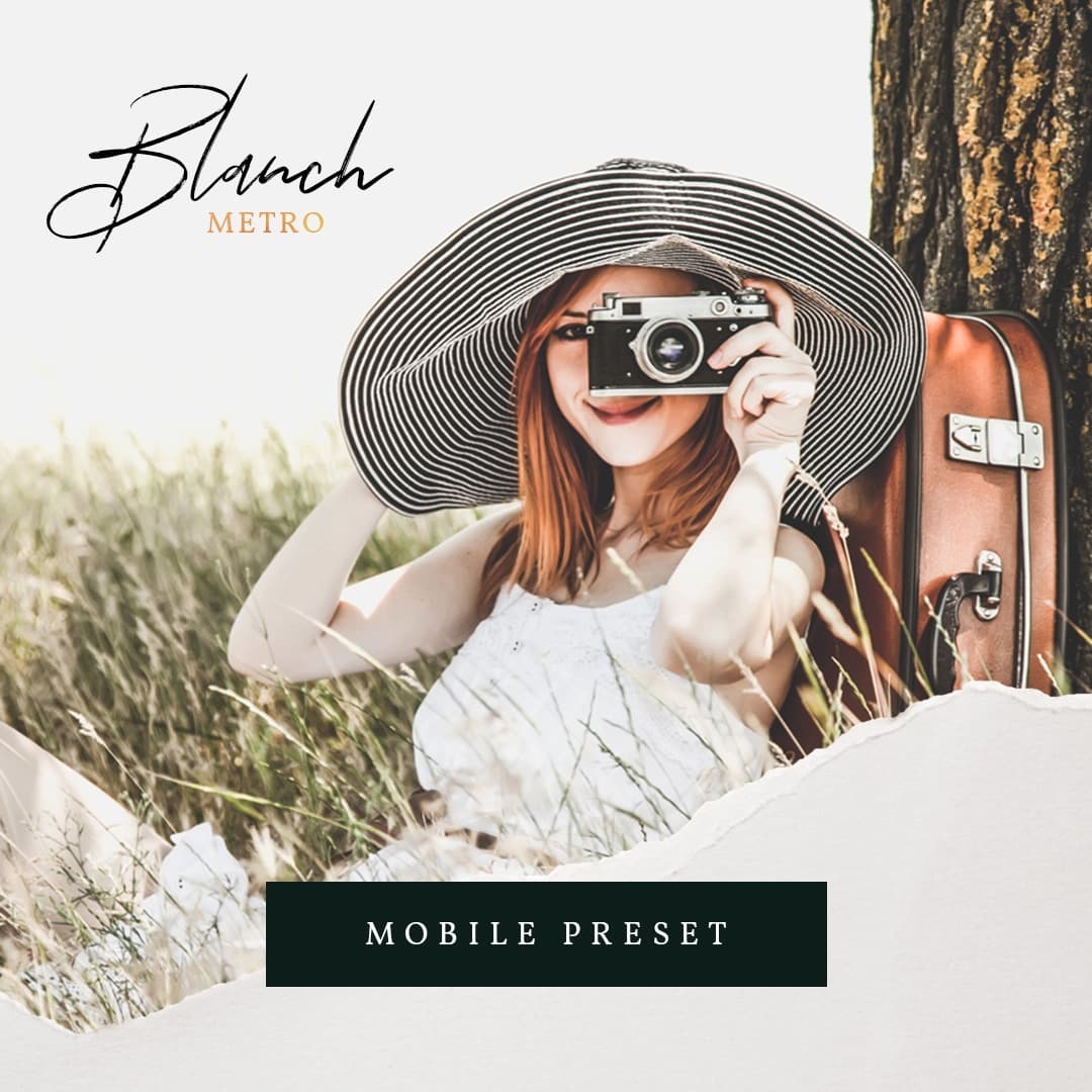 Woman sitting next to tree holding camera up.