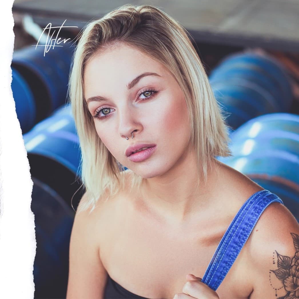 Woman with nose piercing looking at camera.