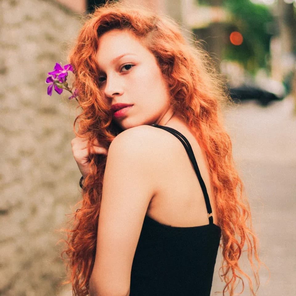 Red hair girl looking over shoulder.