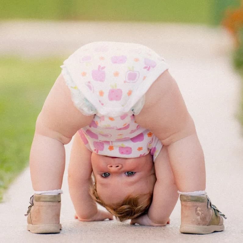 Baby looking between legs.