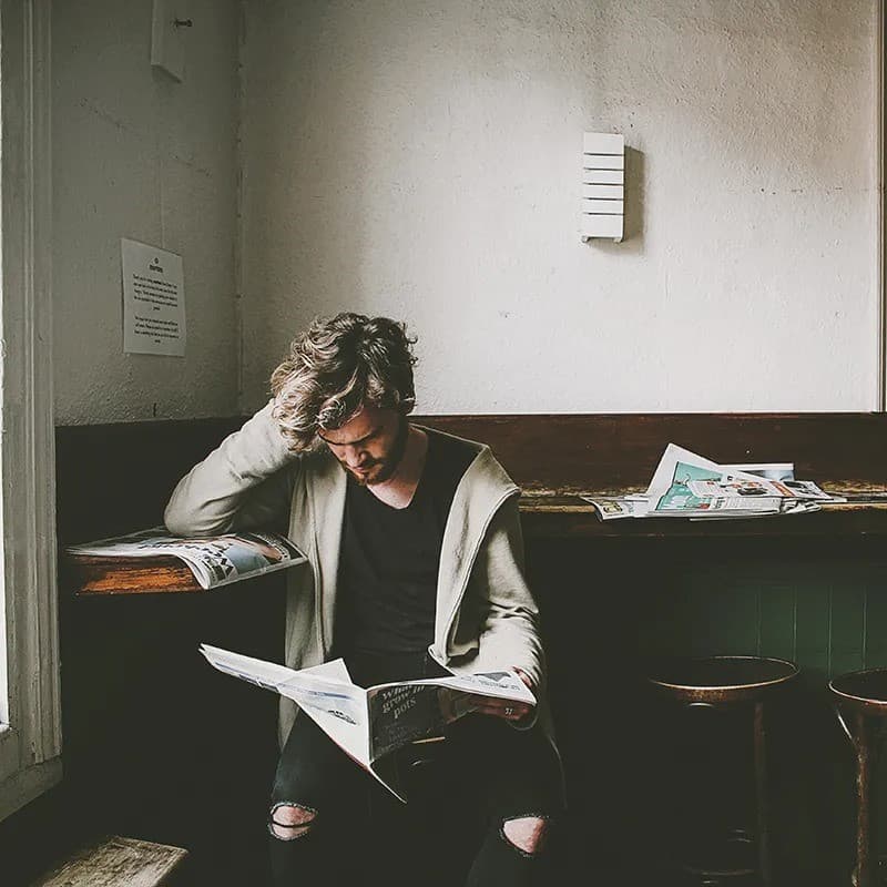 Man reading newspaper.