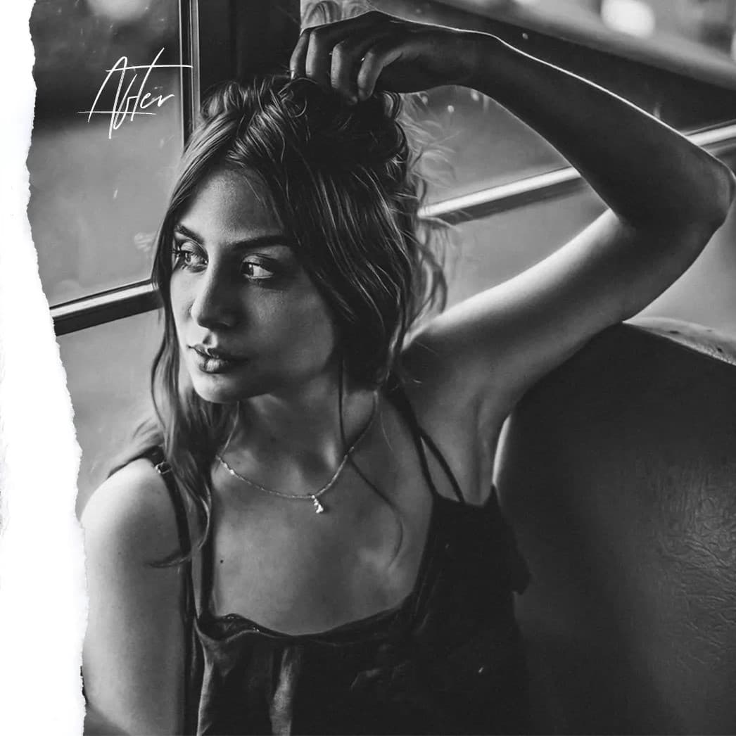 Woman sitting in bus looking out window.