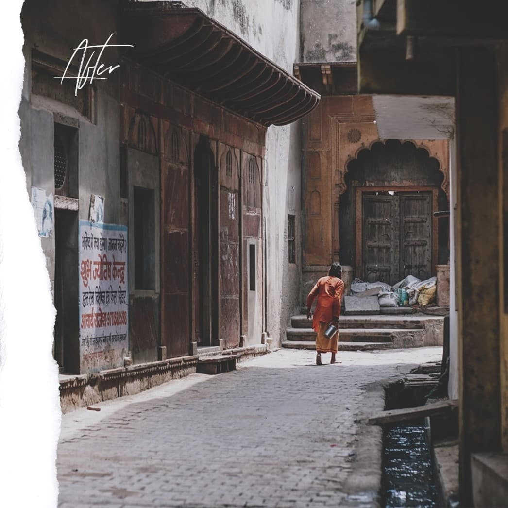 Older man walking down empty street.