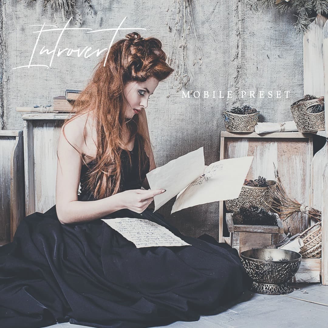 Woman in black dress reading old letters.