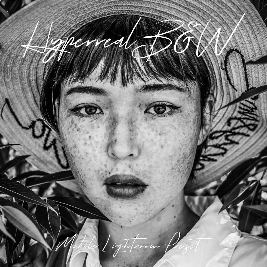 Freckled woman wearing hat looking at camera with serious look.