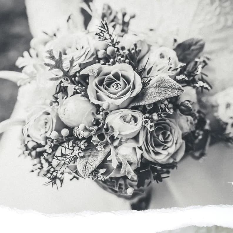 Woman holding bouquet of flowers.