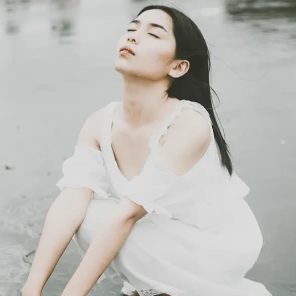 Woman sitting in puddle.