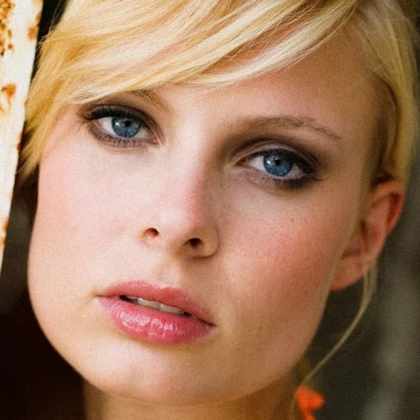 Woman with blue eyes looking directly into camera.