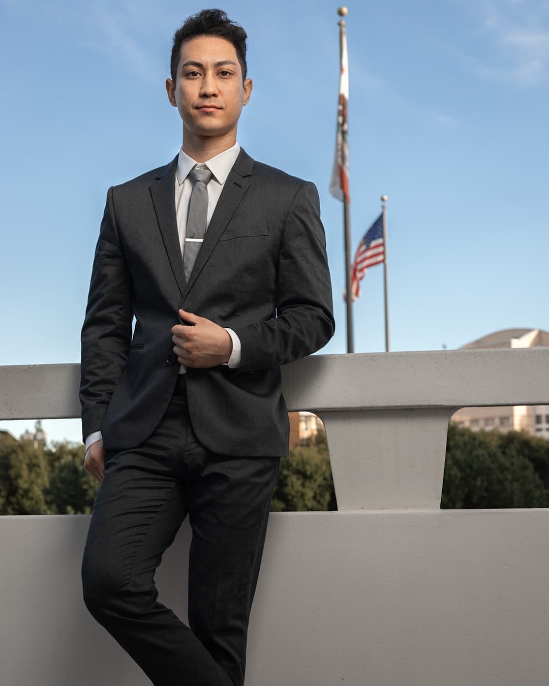 Man posing in suit adjusting his outfit.