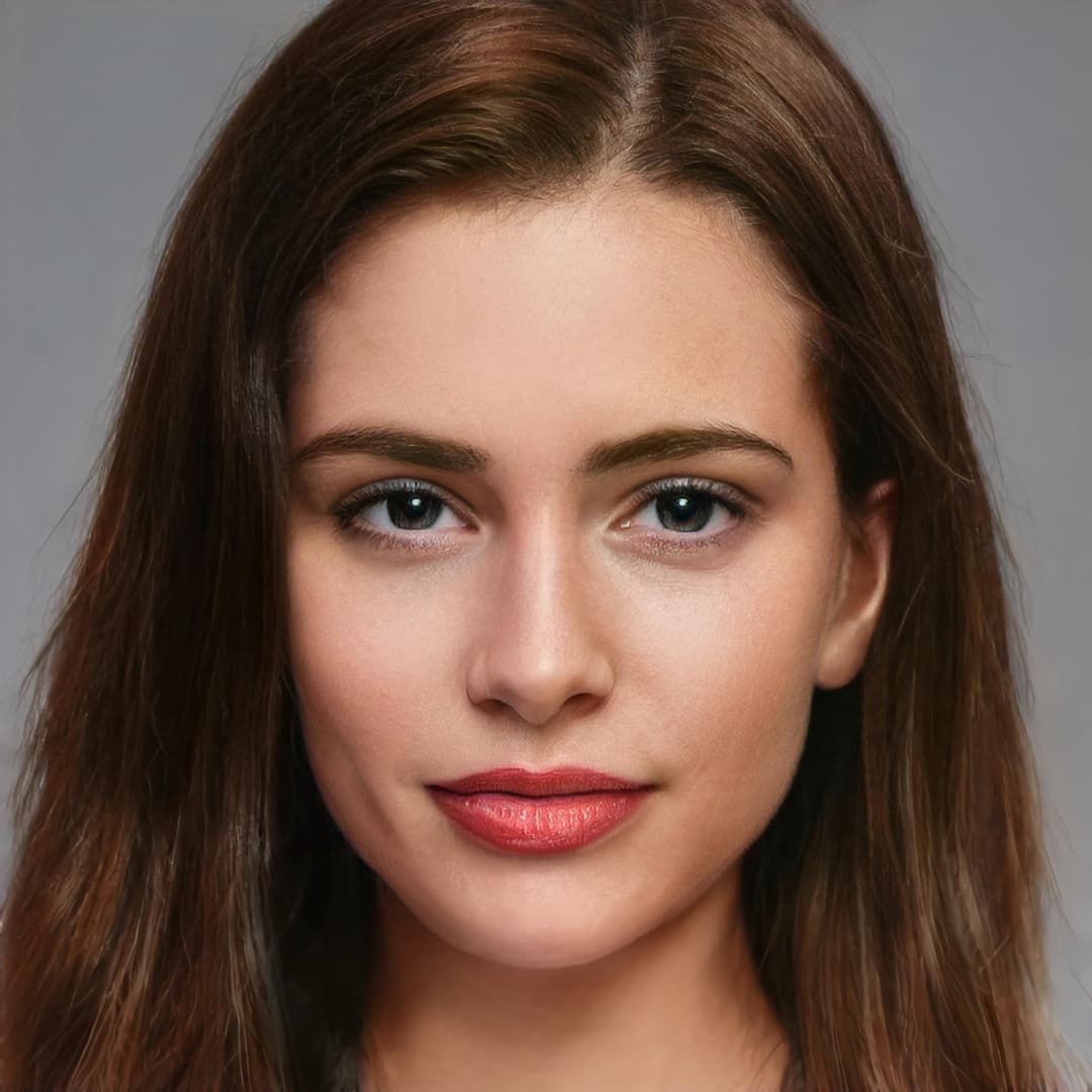 Woman with brown hair smiling at camera.