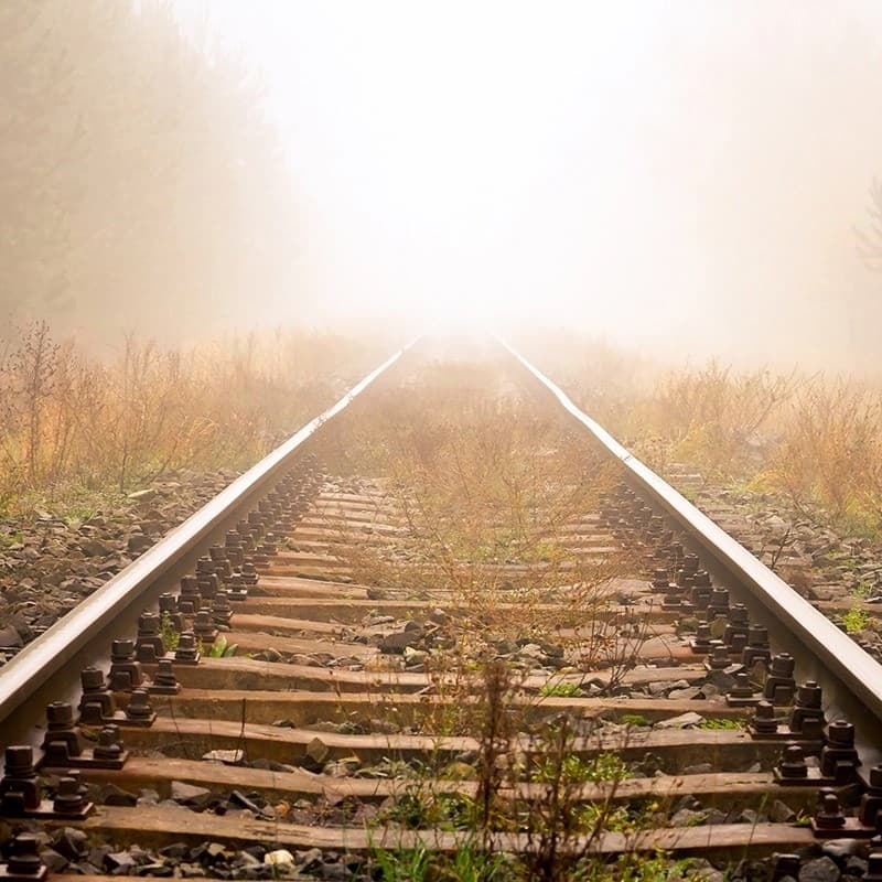 Train rails leading to light.