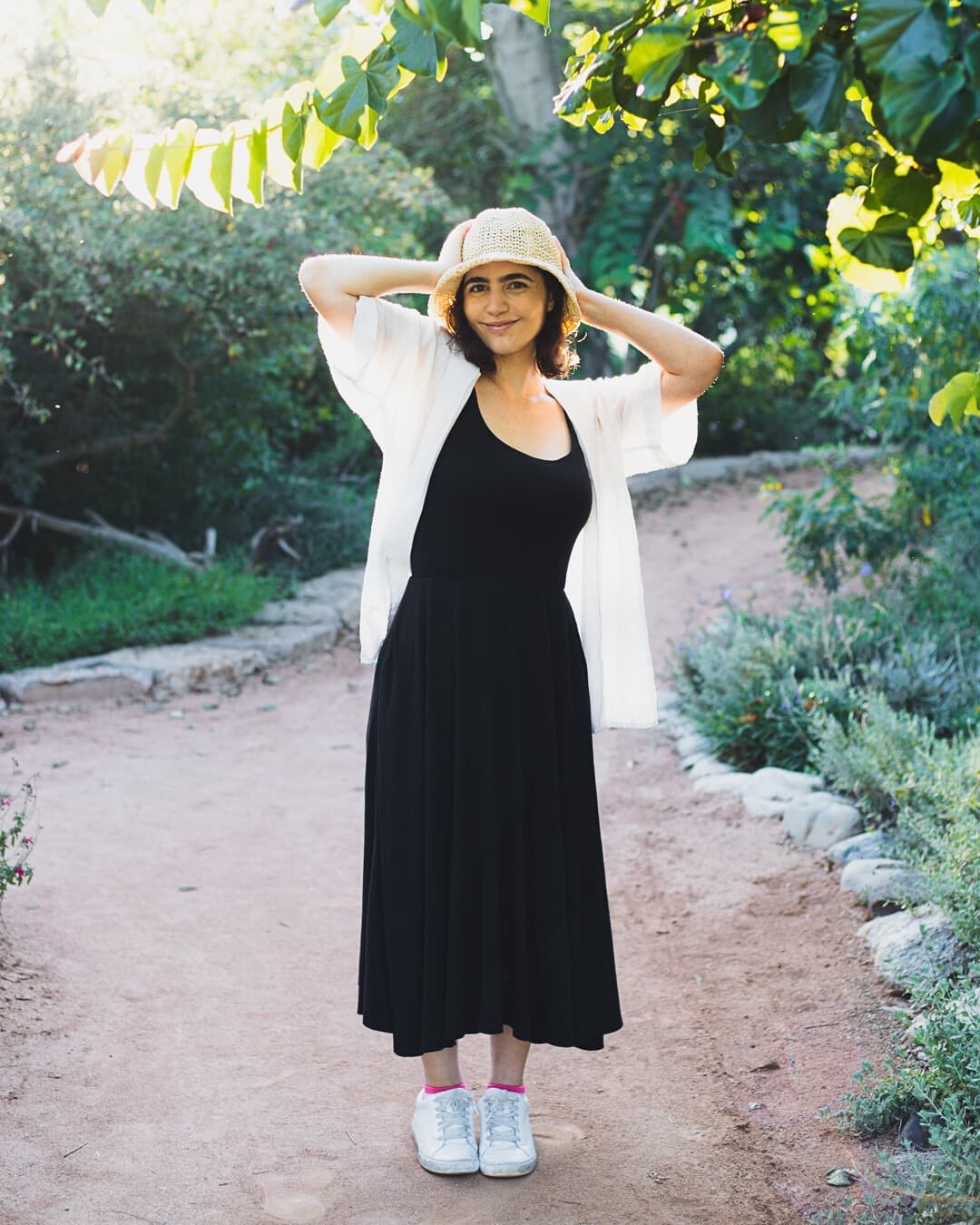 Girl standing in a bright and airy park.