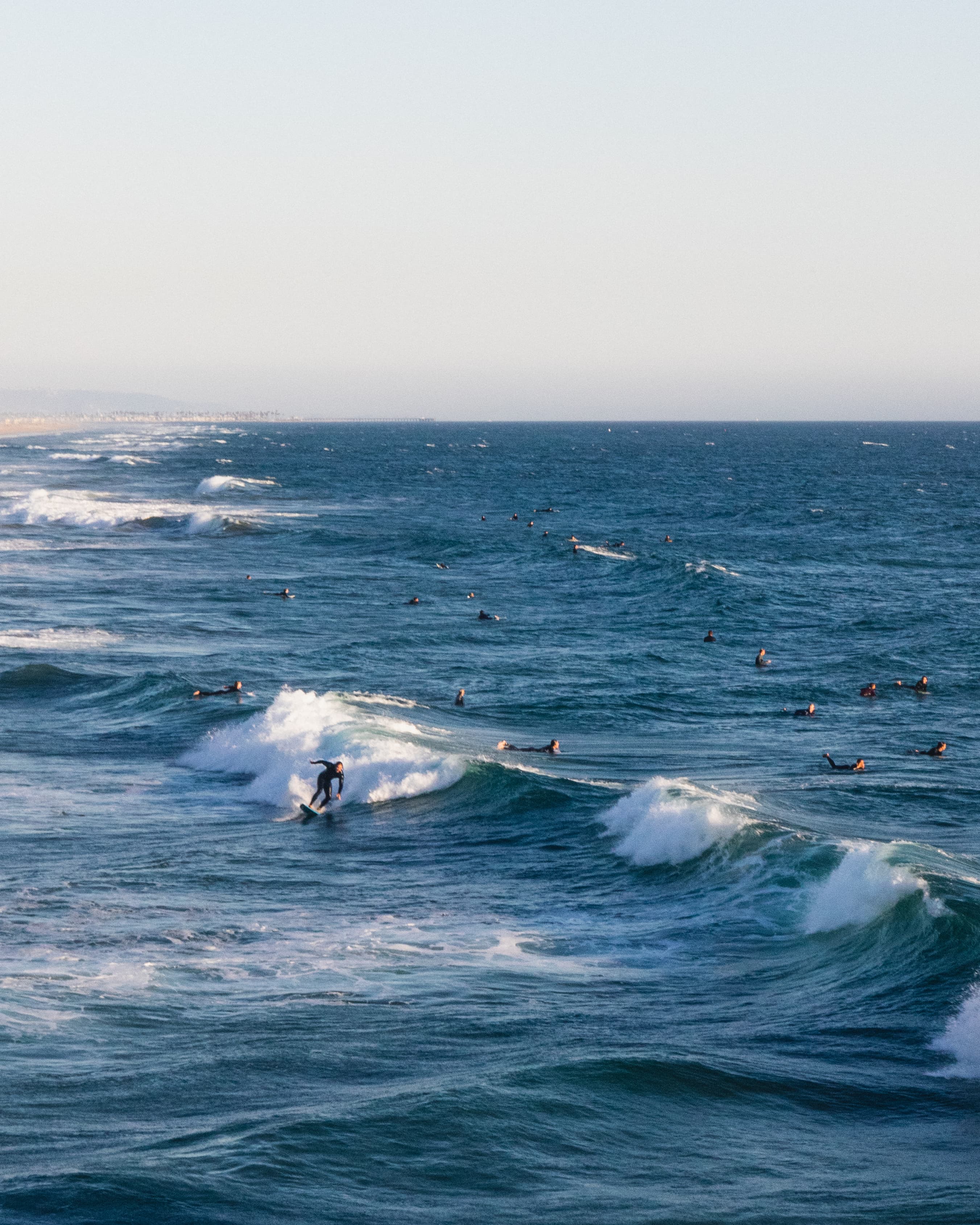 Canon EF 24-70mm f4L IS beach photo of surfers in the water.