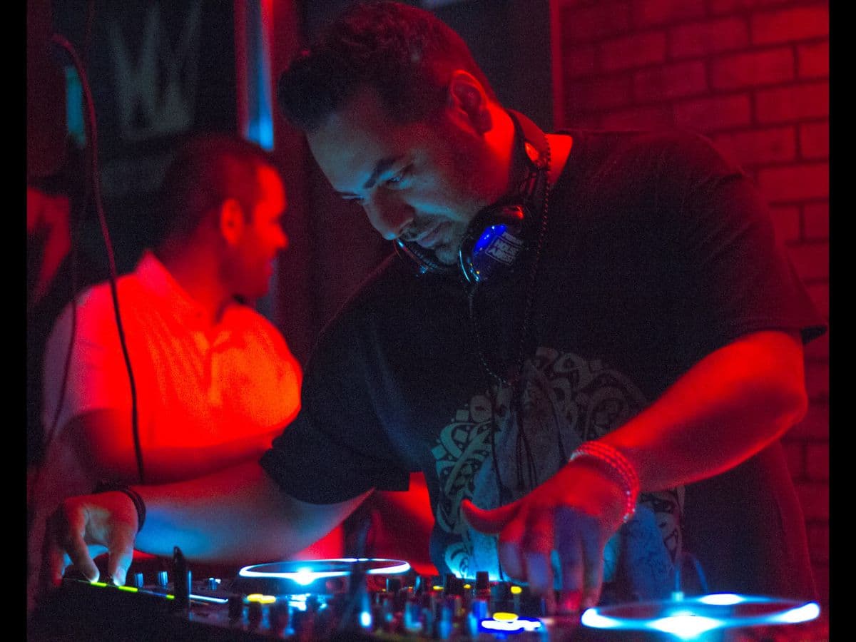 Photo of DJ at night taken with Canon EF 50mm f/1.8 lens.