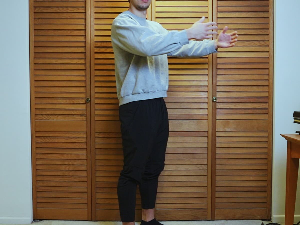 Man posing with his collarbone in same direction as his feet.