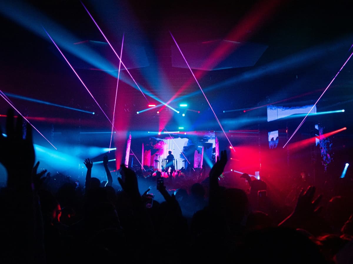 Concert photo with neon lights and crowd.