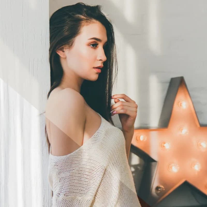 Woman near light up star.