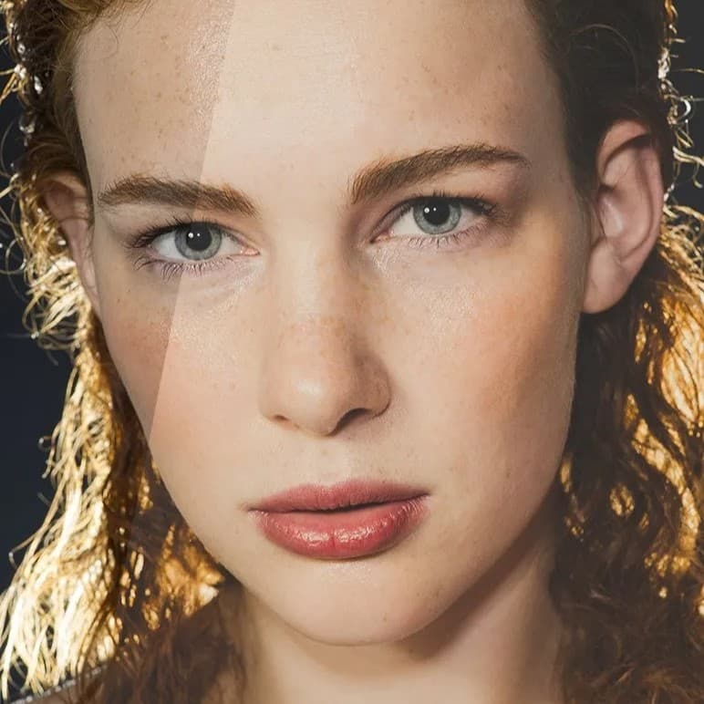 Woman with wet hair and red lipstick.