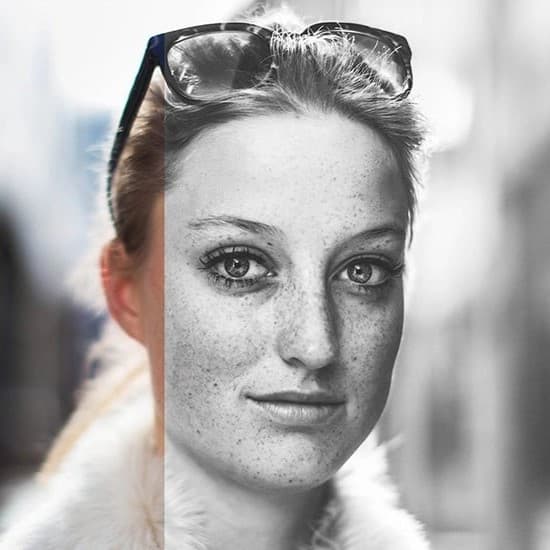 Woman with glasses on her head looking at camera.