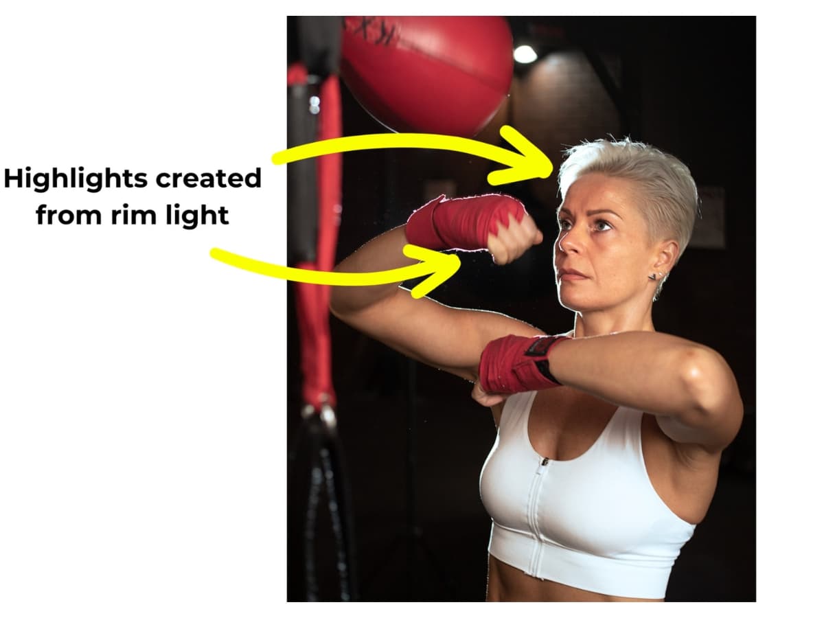 Highlights on model with boxing wraps face due to rim light.