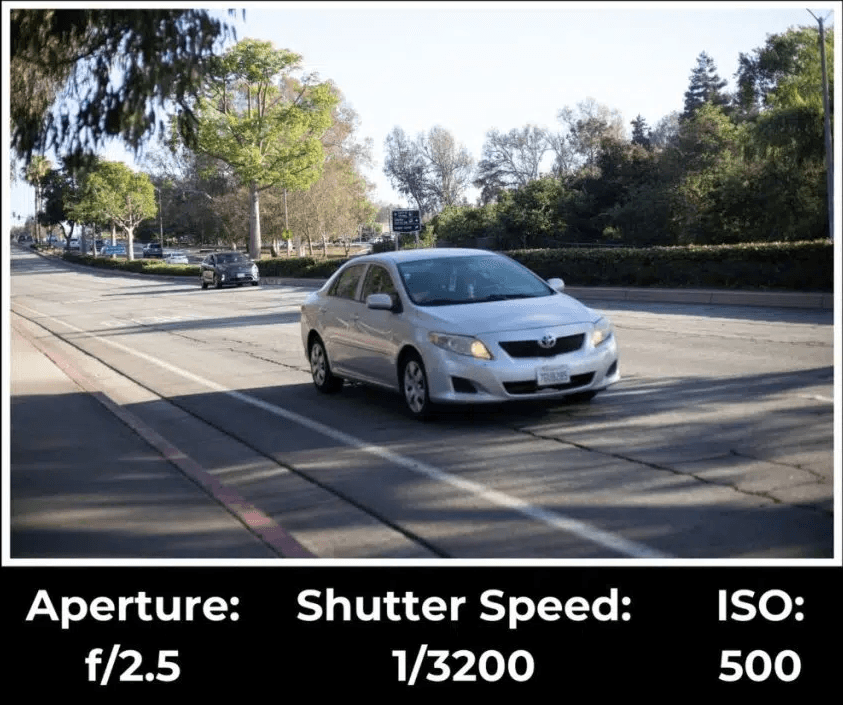 Car frozen on road due to fast shutter speed.