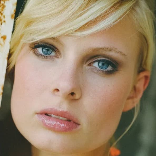 Blonde woman looking at camera.