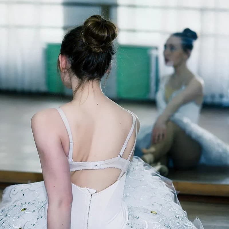 Ballerina stretching on the floor.