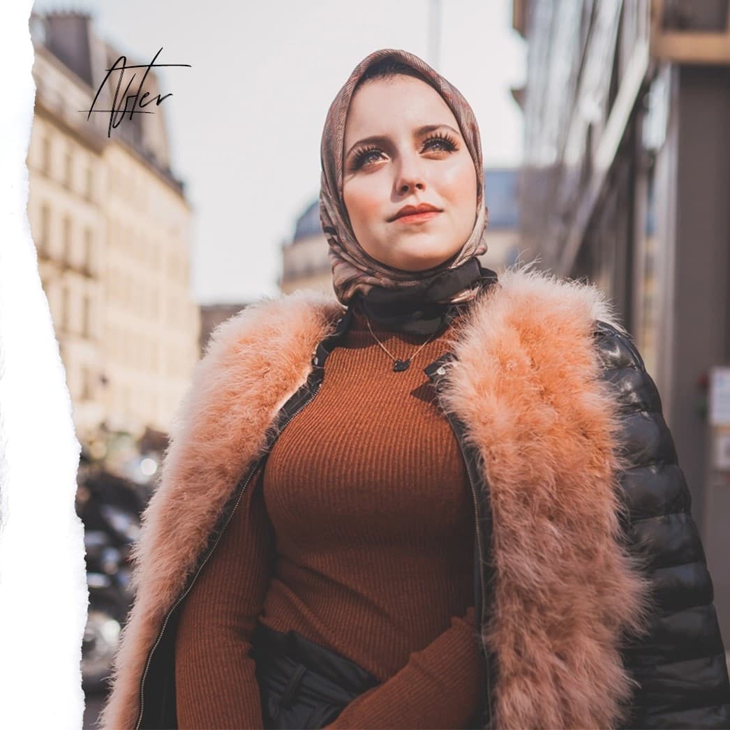 Woman in fur coat smiling.