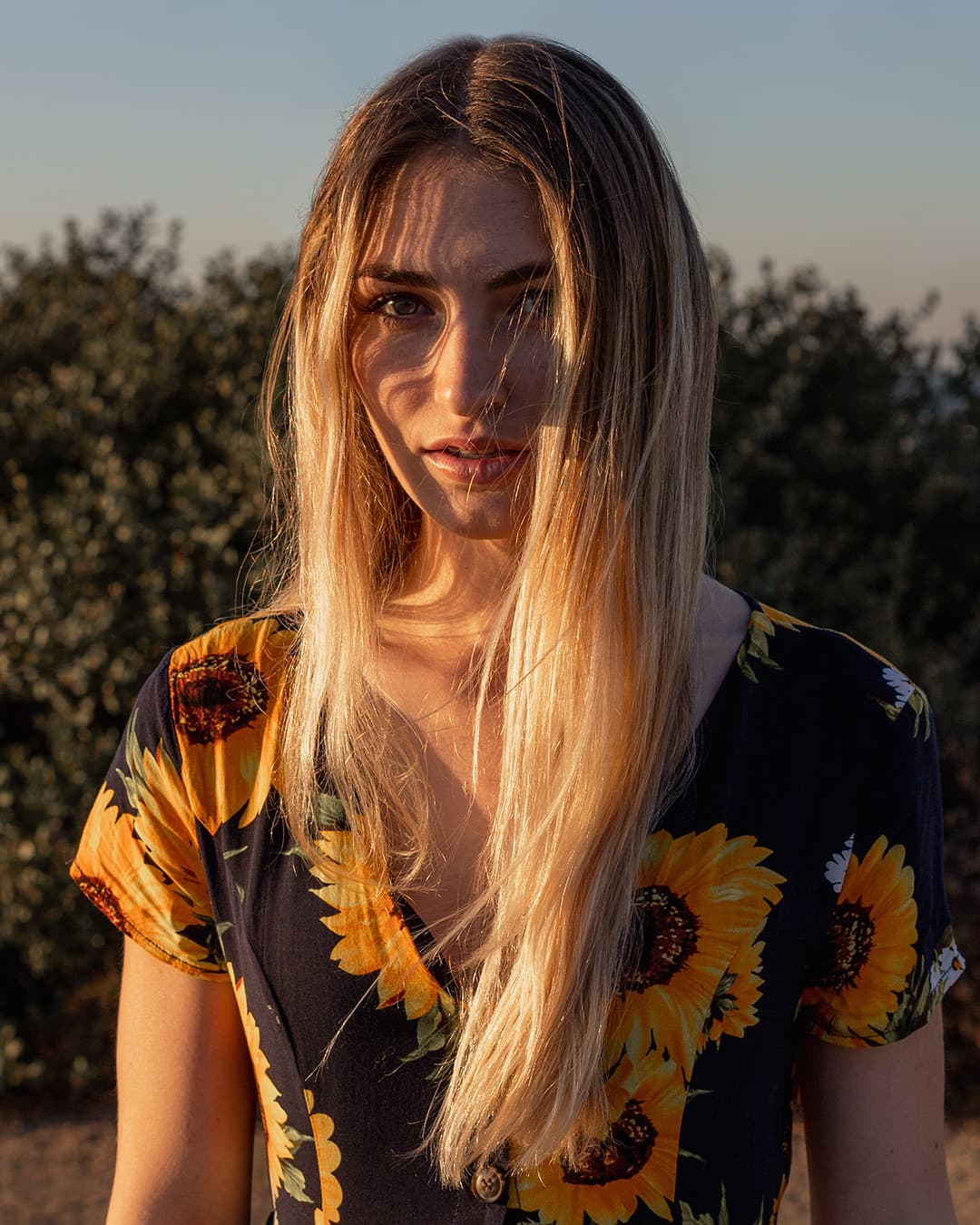Girl facing harsh sunlight during photograph.