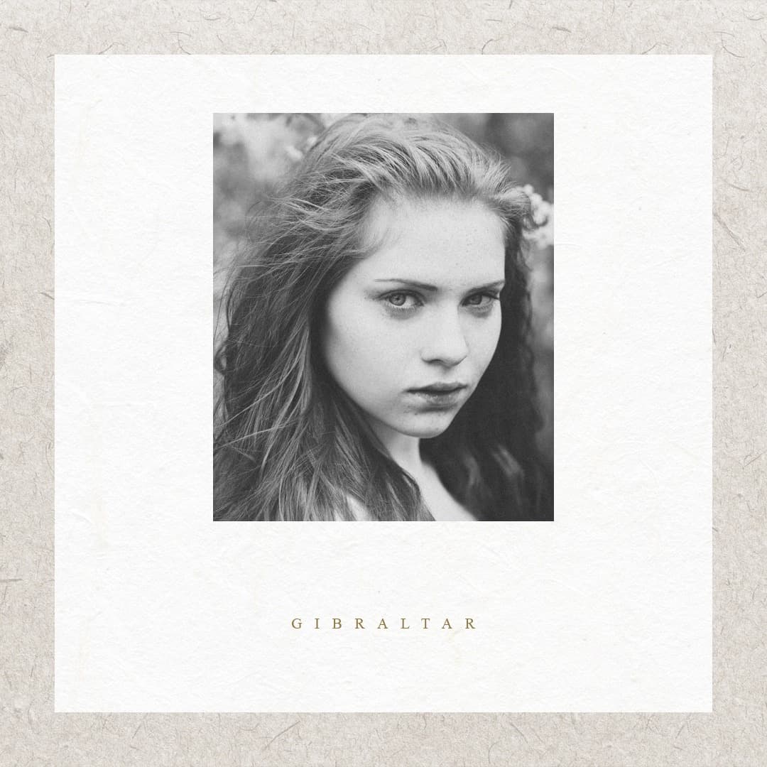 Girl looking at camera with pensive look.