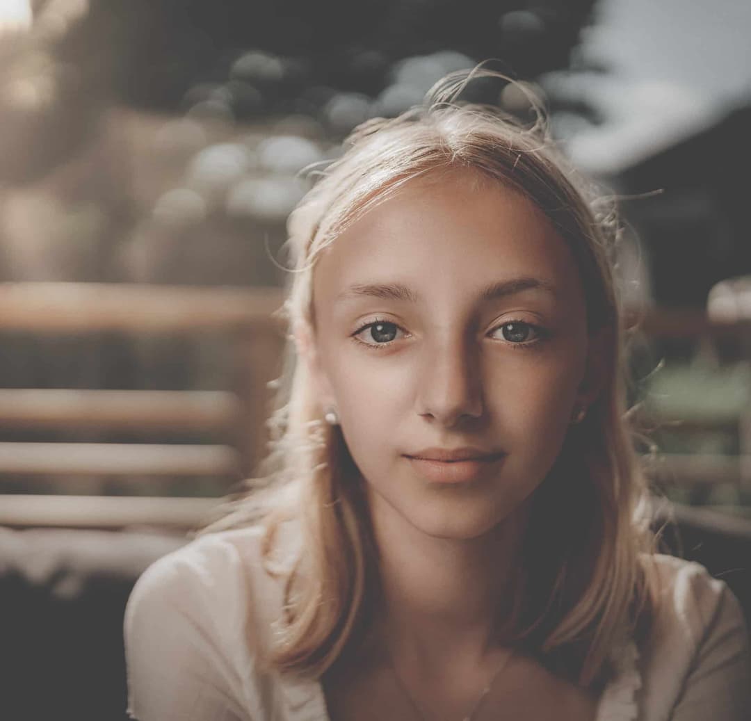 Girl smiling softly at camera.