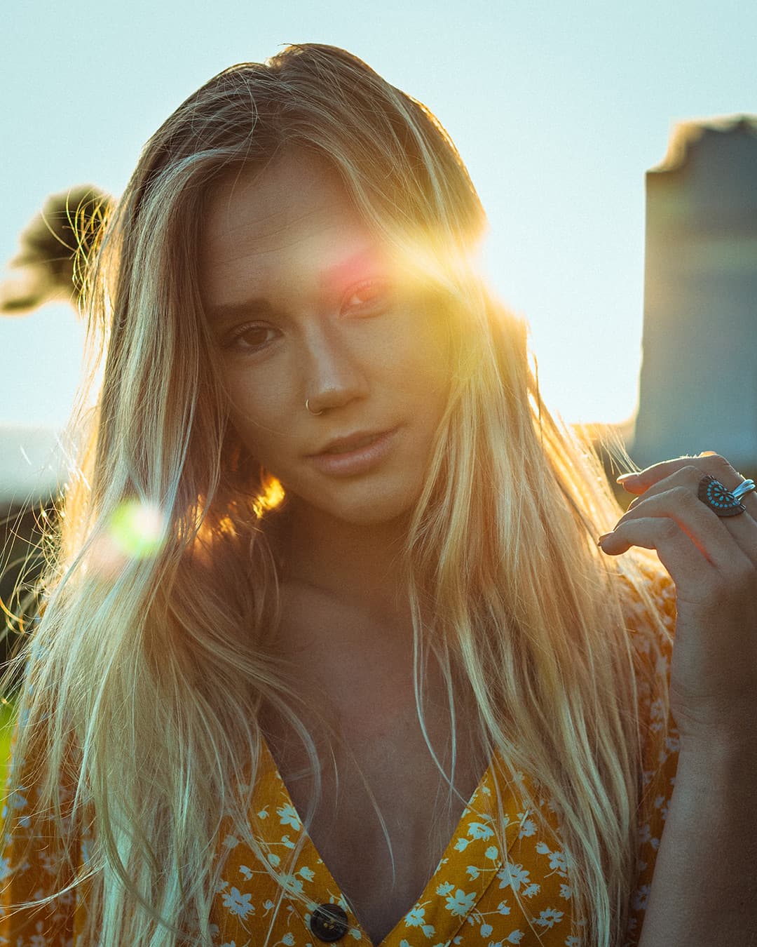 Girl standing in front of sun creating a lens flare.