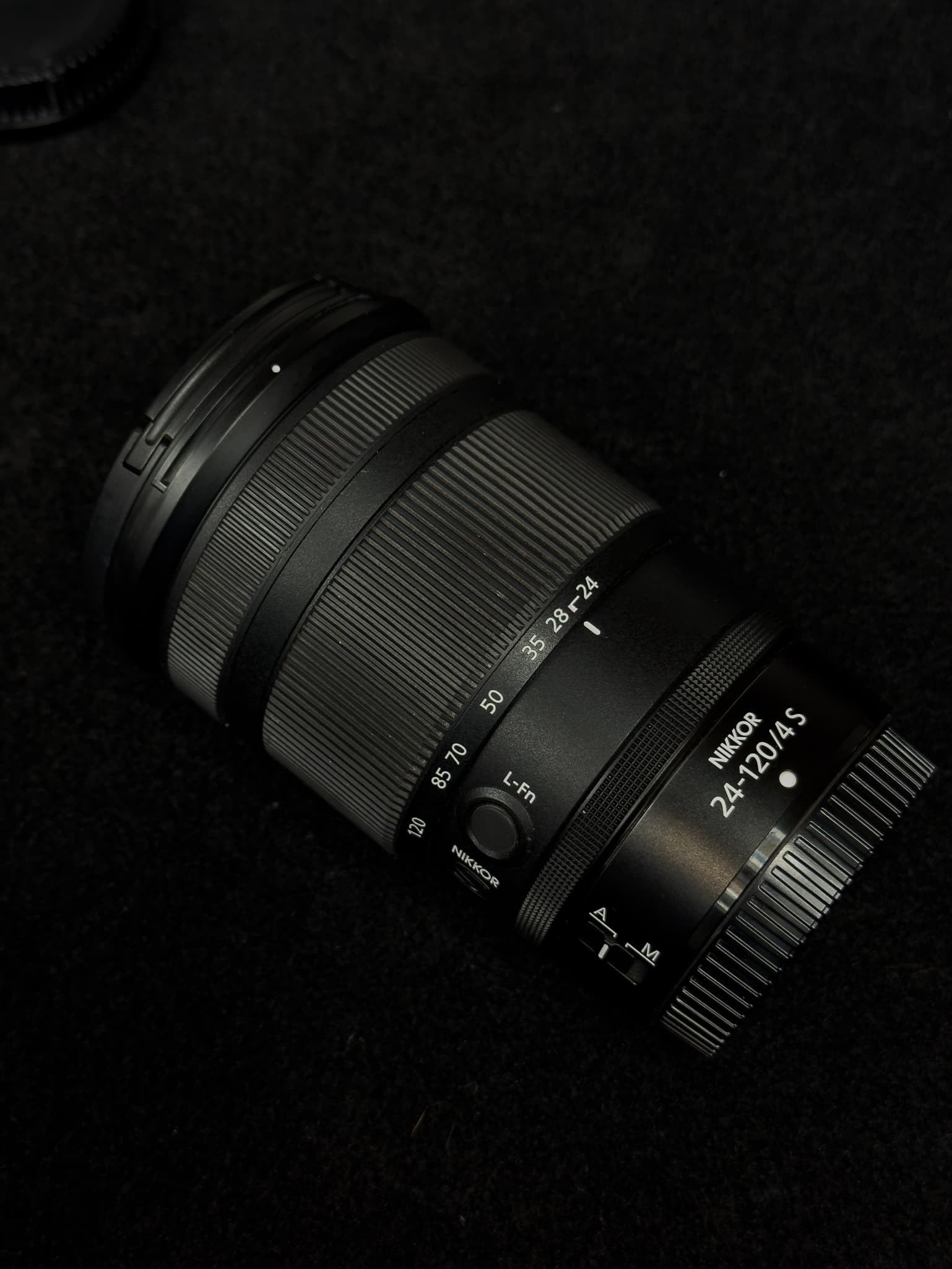 Profile shot of the lens barrel of the Nikon Z 24-120mm f/4 S at its collapsed 24mm state, focusing on the cleanly engraved focal length markings (24, 35, 50, 70, 85, 120)