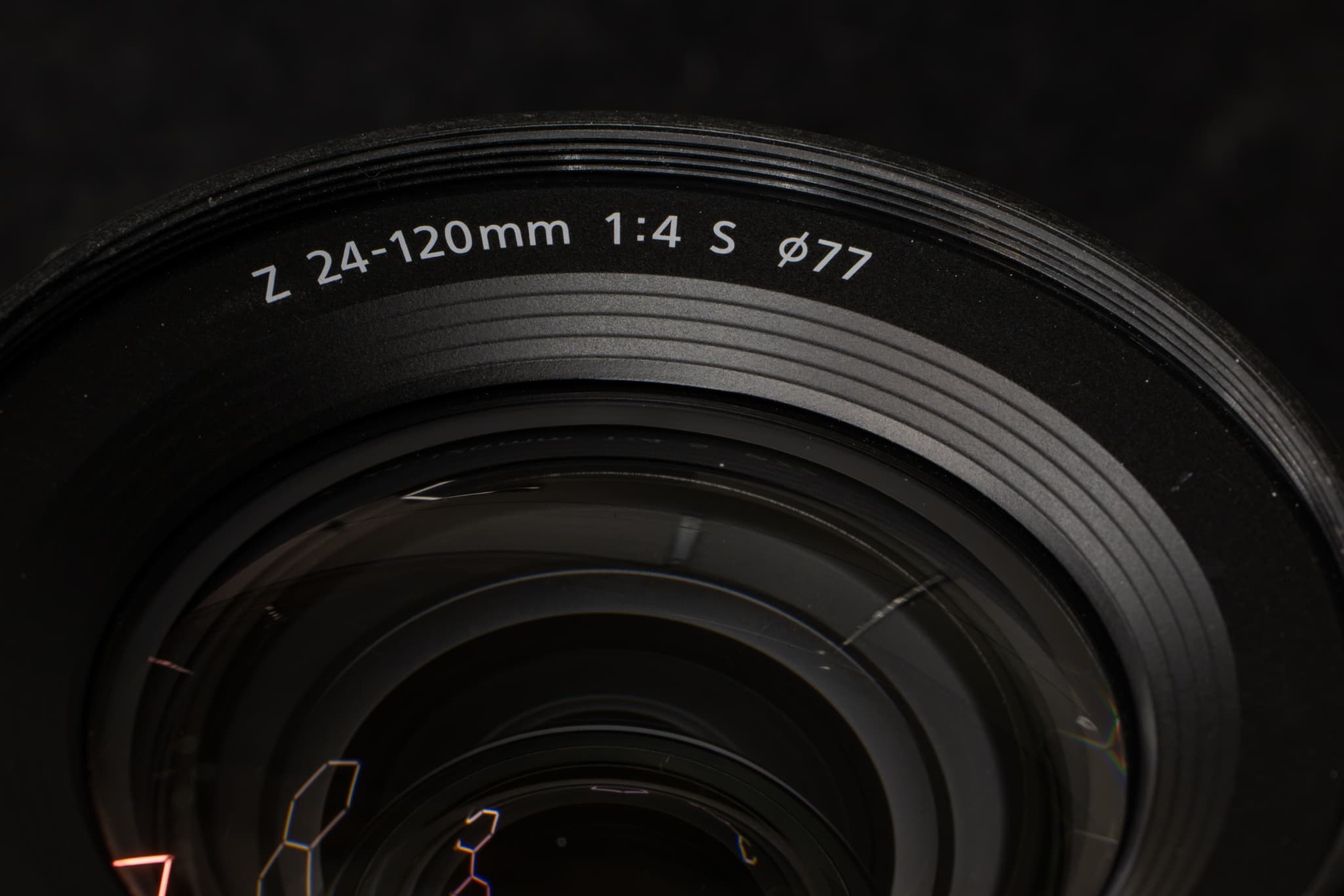 Shot detailing the front lip of the Nikon Z 24-120mm f/4 S, clearly showing the precision-cut 77mm filter threads