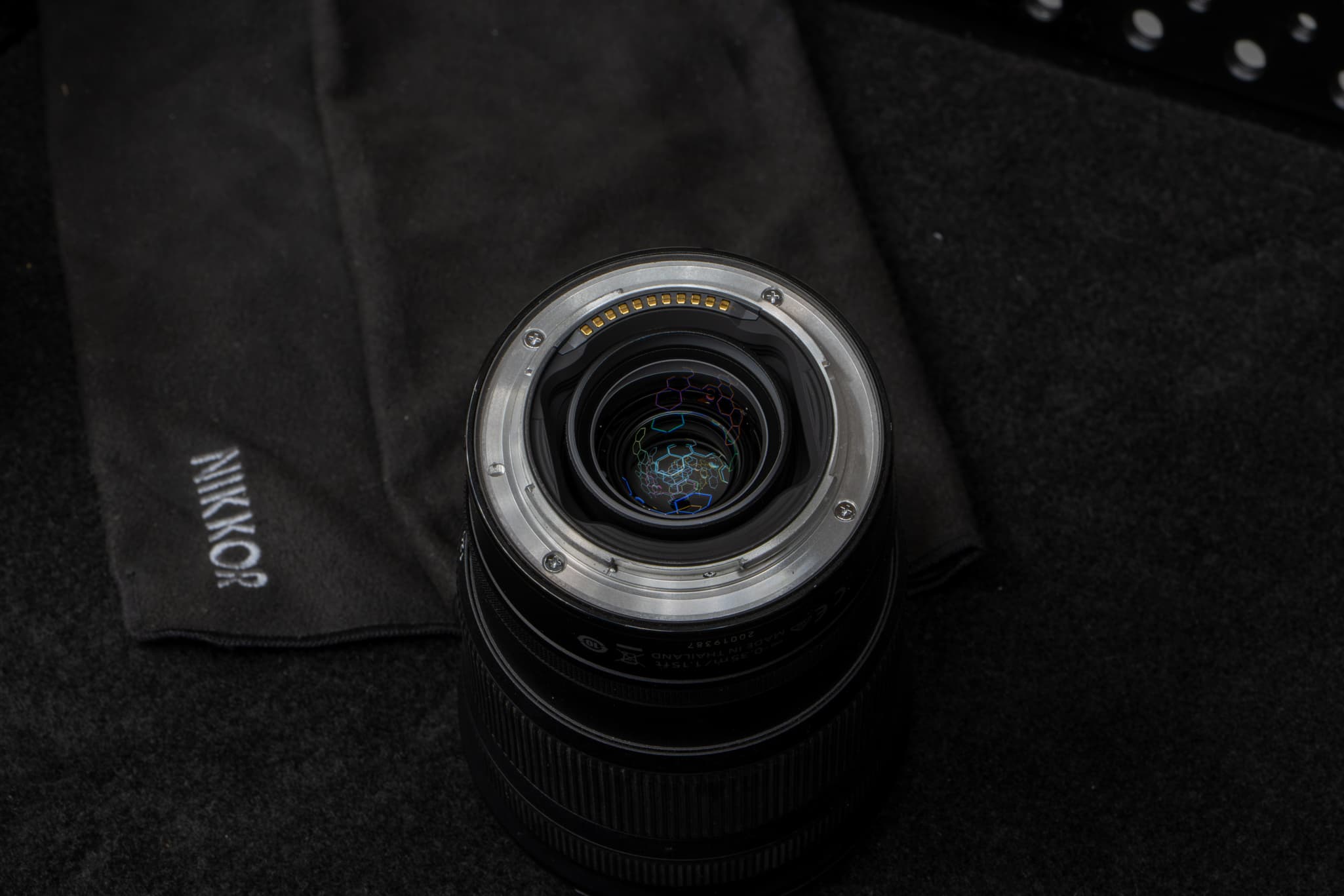 Close-up focusing directly on the rear metal mount interface of the Nikon Z 24-120mm f/4 S, highlighting the thick, prominent black rubber weather-sealing gasket designed to keep dust, moisture, and debris out of the camera sensor chamber