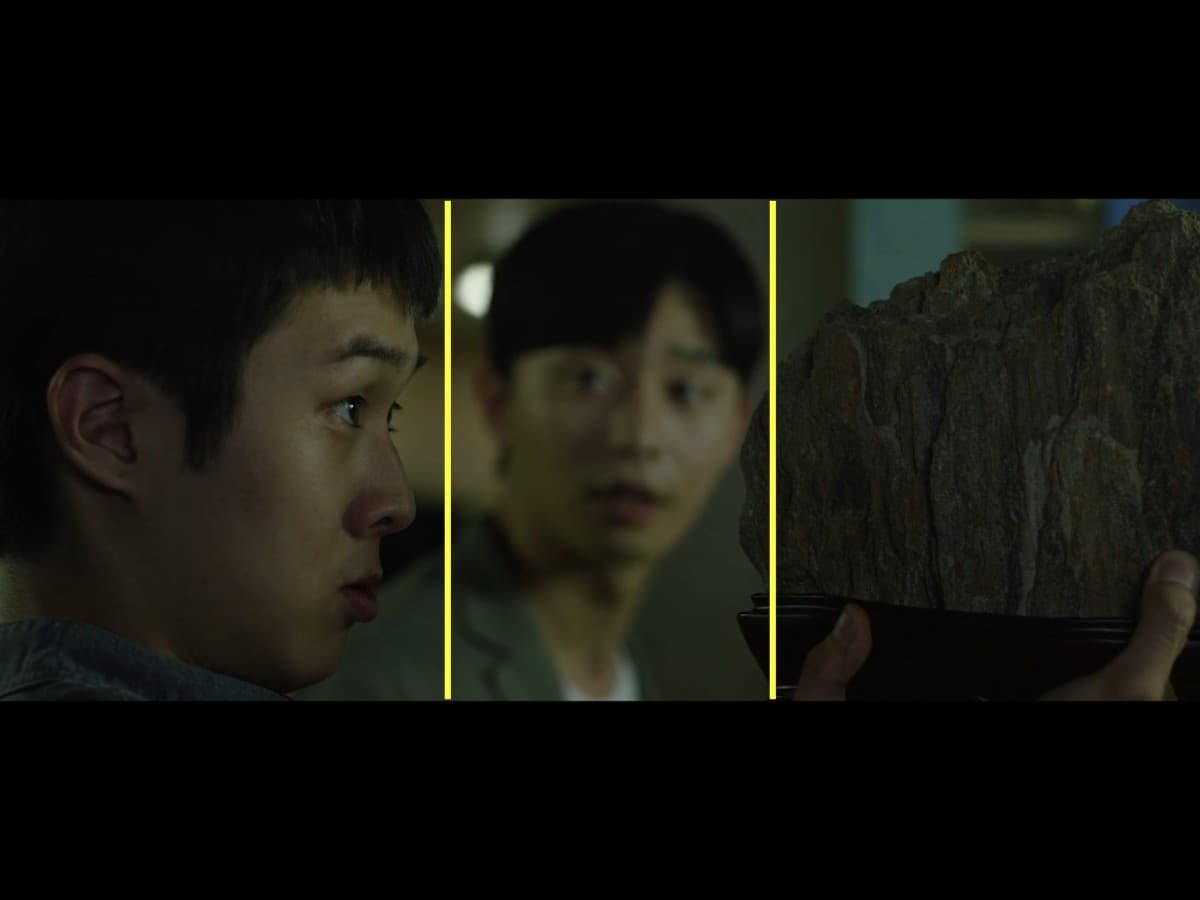 Composition from scene from Parasite where Ki-Woo is gifted scholar's rock.
