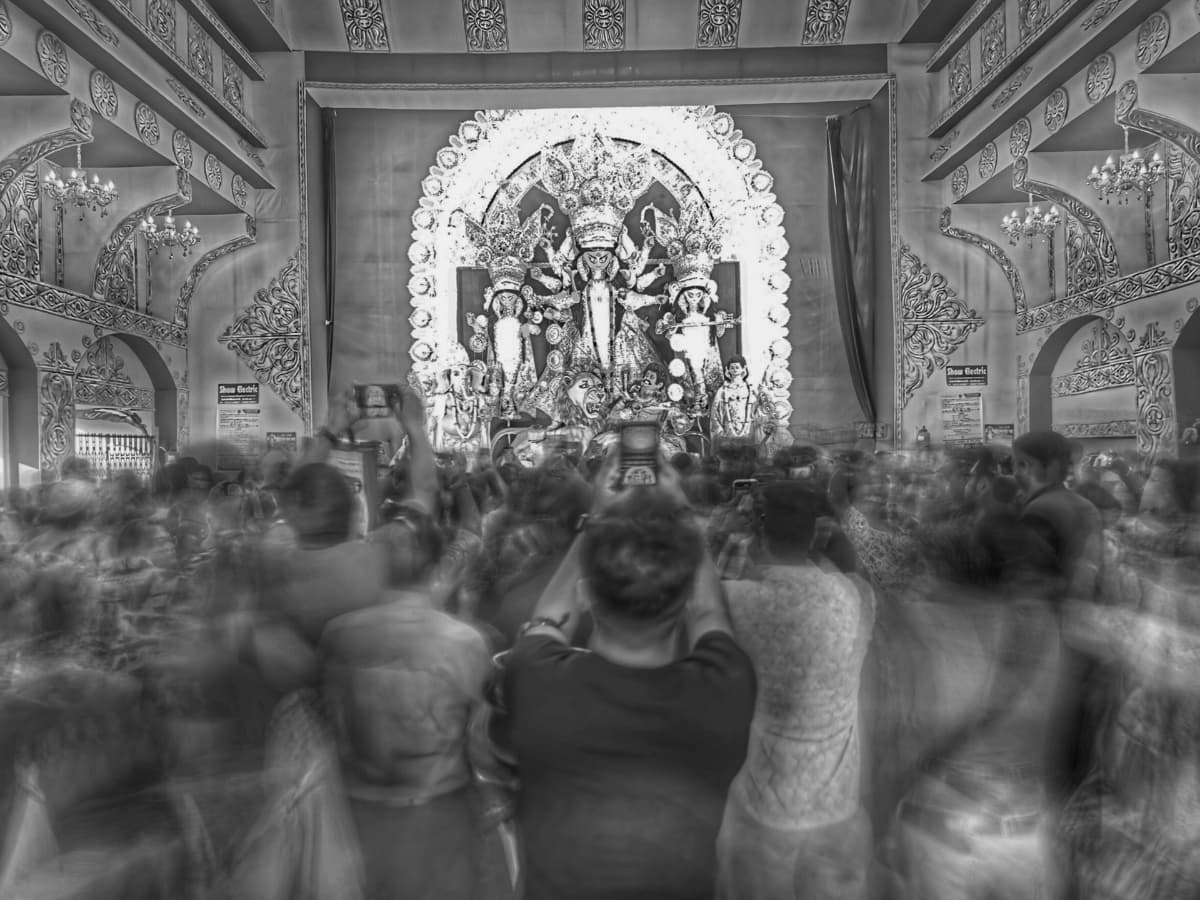 People taking photos in a temple.