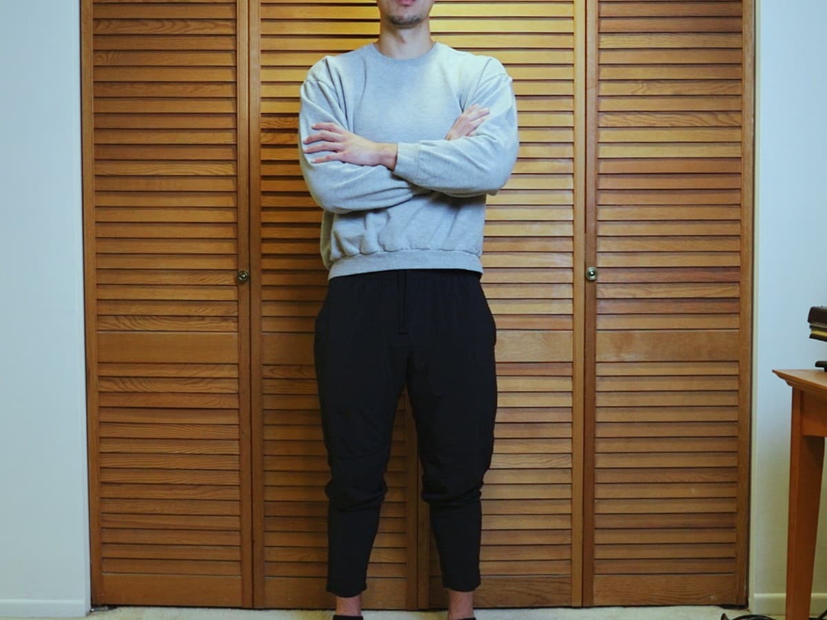 Man posing by crossing arms.