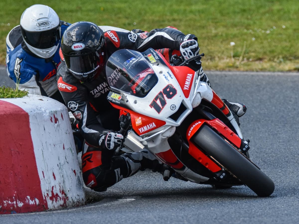 Sports photo of two motorcyclists on a track.