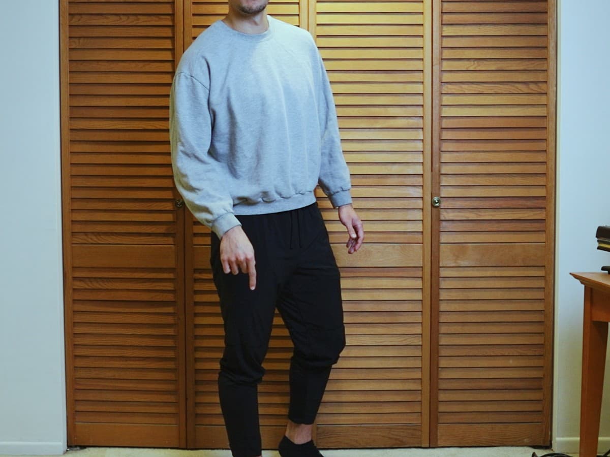Man posing by standing and putting weight on front foot.