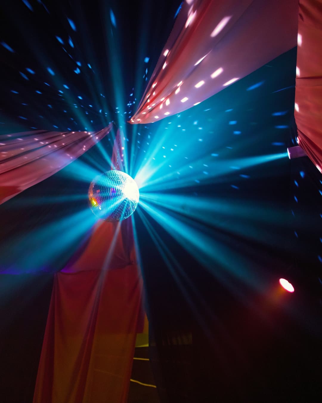 Streak lens flare from light hitting disco ball.