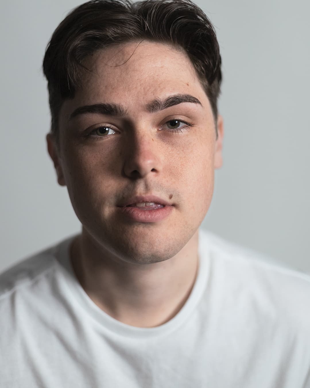 Commercial headshot of man wearing white shirt.