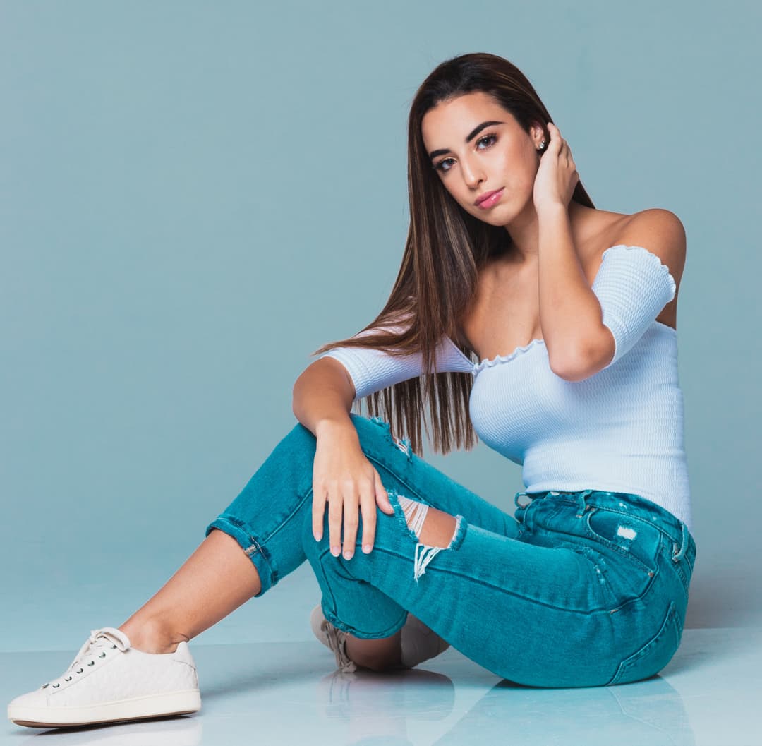 Girl on floor rubbing her neck.
