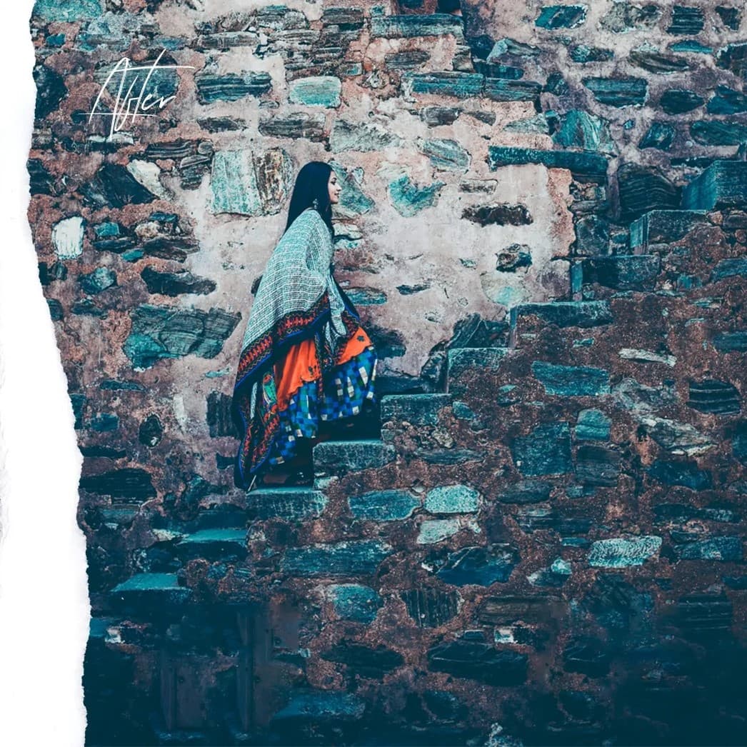 Woman walking up brick stairs.