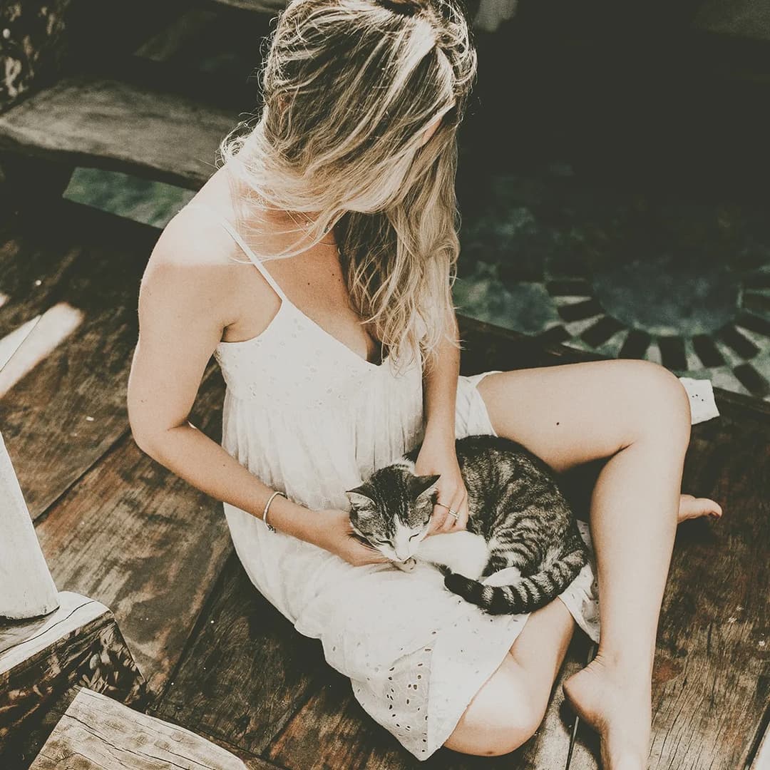 Woman petting a cat.