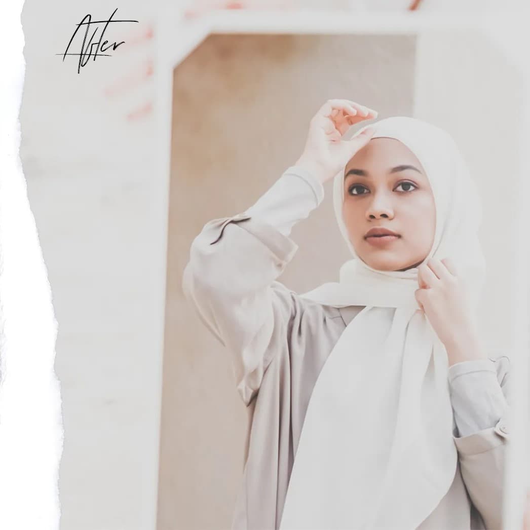 Woman wearing hijab smiling.
