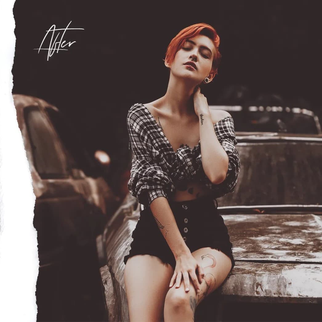 Woman sitting on old car touching back of her neck.
